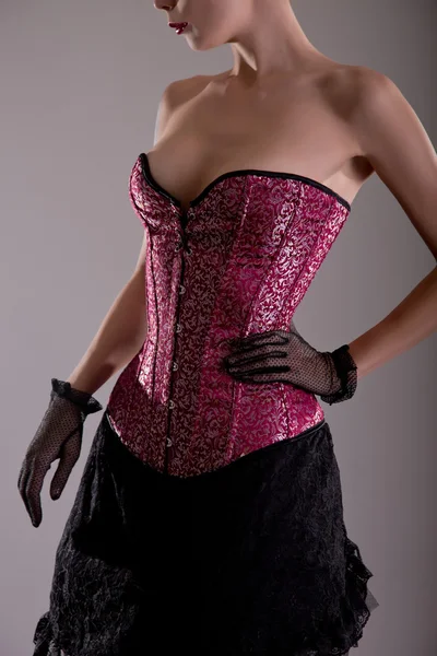 Donna in corsetto rosa — Foto Stock