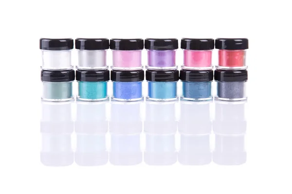 Two rows of loose eye shadows in plastic jars — Stock Photo, Image