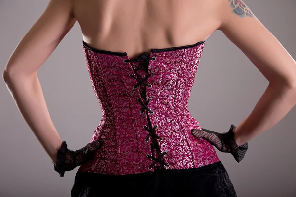 Rear view of woman wearing purple corset Royalty Free Stock Photos