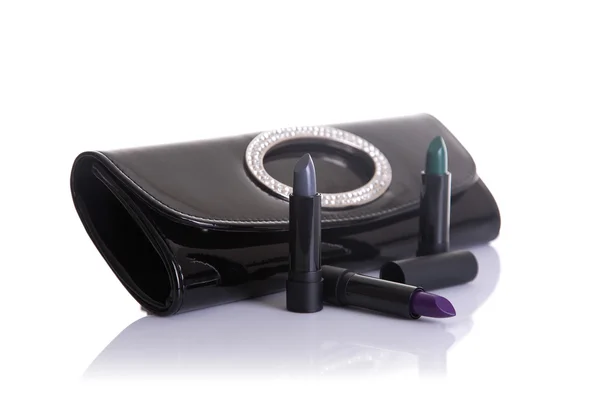Black handbag clutch and lipsticks — Stock Photo, Image
