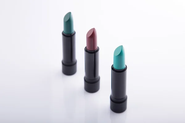 Row of three lipsticks — Stock Photo, Image