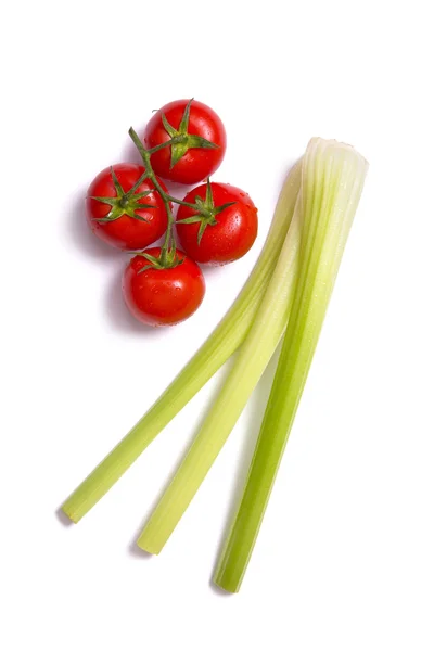 Bunch of fresh tomatoes and celery sticks — Stock Photo, Image