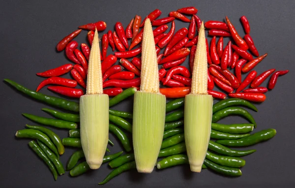 Corn cobs and non-stem chili peppers — Stock Photo, Image