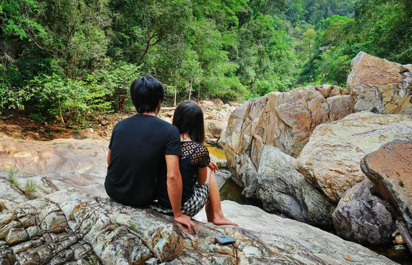 Couple sitting on a rock