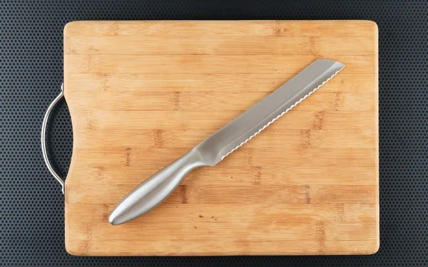Kitchen cutting board and knife on a table