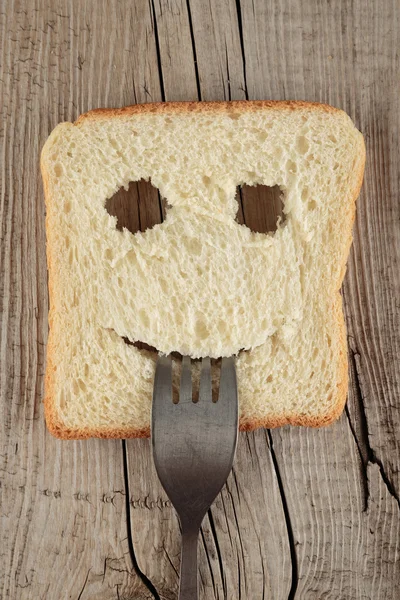 Happy toast with a fork in mouth