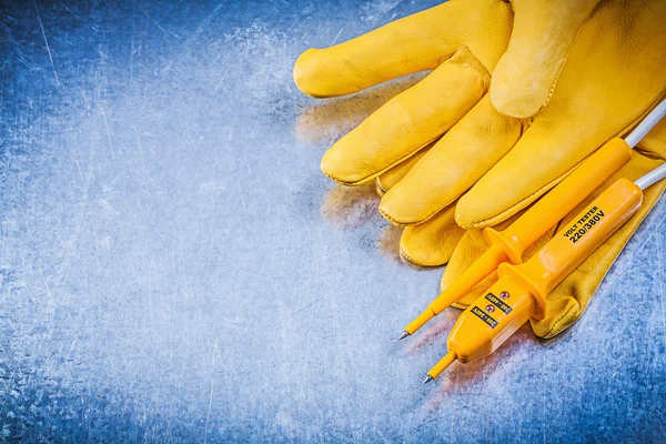 Yellow electrical tester, safety gloves — Stock Photo, Image