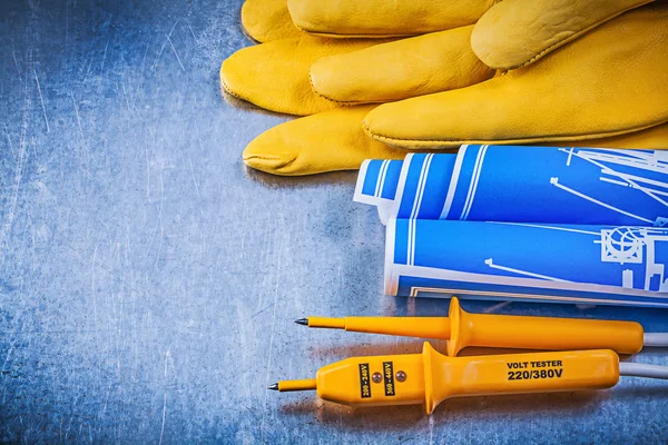 Yellow electrical tester, protective gloves — Stock Photo, Image