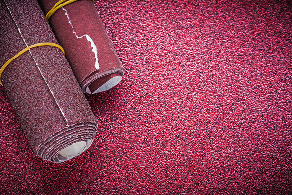 Rolled sandpaper on abrasive sheet