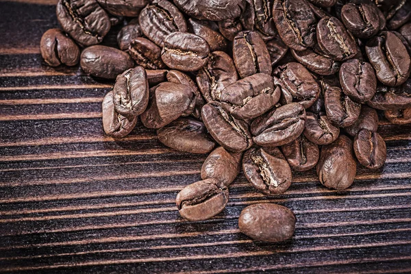 Granos de café sobre tabla de madera —  Fotos de Stock