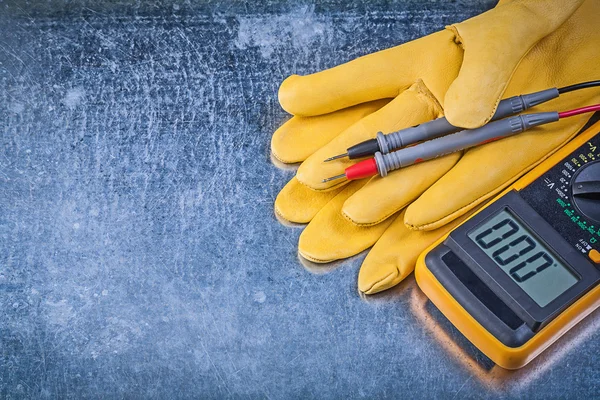 Digital electric tester and protective gloves — Stock Photo, Image