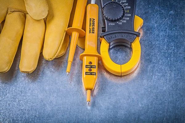 Digital clamp meter, tester and gloves — Stock Photo, Image