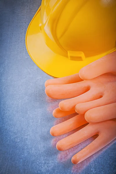 Insulating rubber gloves and building helmet — Stock Photo, Image