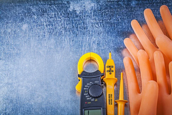 Digital ammeter, tester and rubber gloves — Stock Photo, Image