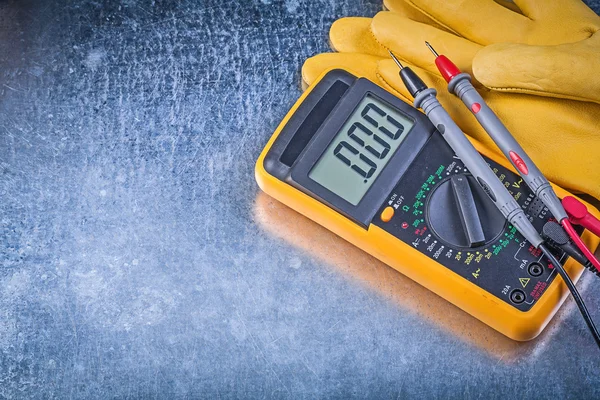Digital electric tester and safety gloves — Stock Photo, Image