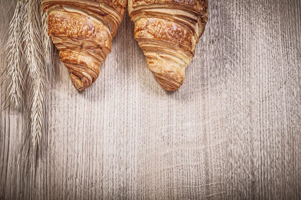 Wheat and rye ears and croissants — Stock Photo, Image