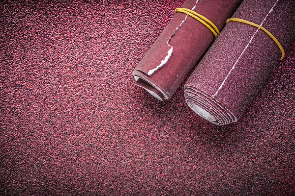 Rolled glass-paper on abrasive sheet — Stock Image Rolled glass-paper on abrasive sheet Royalty Free Stock Photos