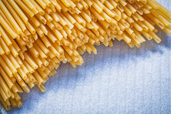 Heap of spaghetti on blue — Stock Photo, Image