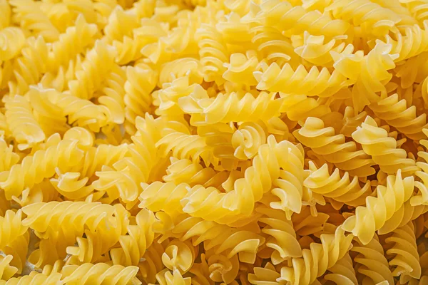 Spiral rå pasta bakgrund — Stockfoto