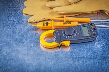 Clamp meter, electrical tester and gloves clipart