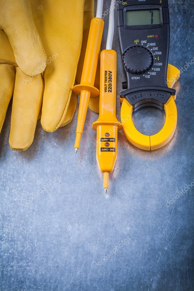 Clamp meter, electrical tester and gloves — Stock Photo © mihalec