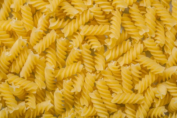 Spiral uncooked macaroni wallpaper — Stock Photo, Image