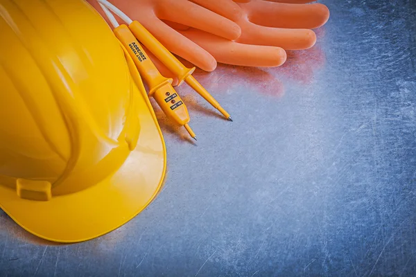 Insulating gloves, helmet and electrical tester — Stock Photo, Image