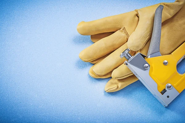 Leather protective gloves and construction stapler — Stock Photo, Image