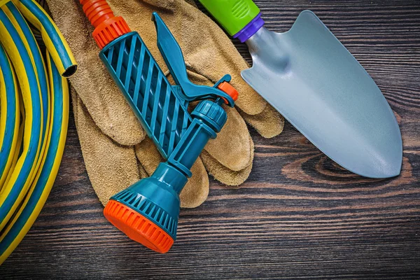 Protective gloves and hand shovel — Stock Photo, Image