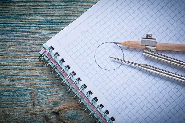 Vintage drawing compass pencil checked copybook on wood board co — Stock Photo, Image