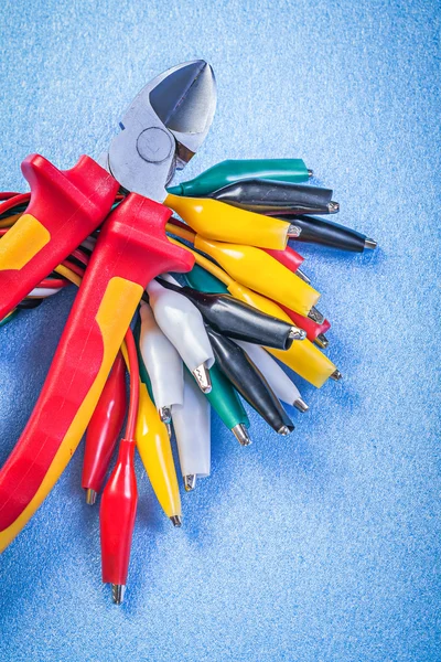 Composition of multicolored cable crocodiles nippers — Stock Photo, Image