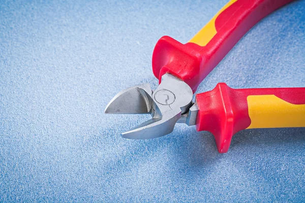 Cutting pliers on blue — Stock Photo, Image