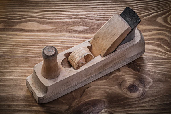 Shaving plane on vintage wooden board — Stock Photo, Image