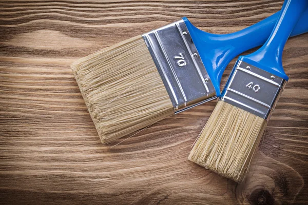 Paint brushes on wooden board construction concept — Stock Photo, Image