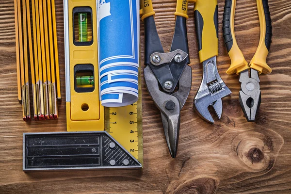 Variation of construction tools on vintage wooden board — Stock Photo, Image