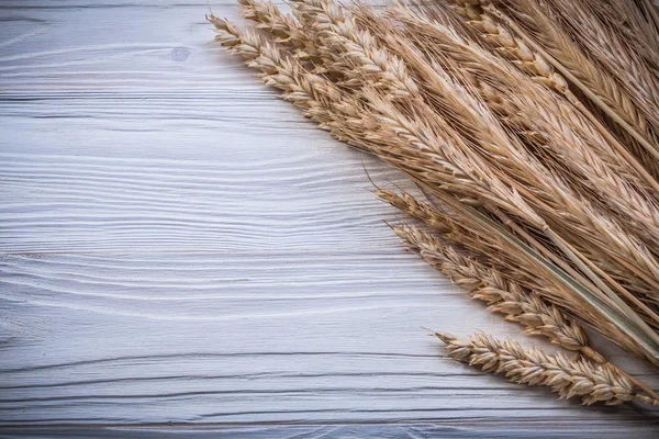Bunch of golden wheat rye ears on wooden board food and drink co — Stock Photo, Image
