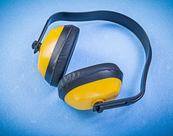 Protective ear muffs on blue background construction concept — Stock Photo, Image