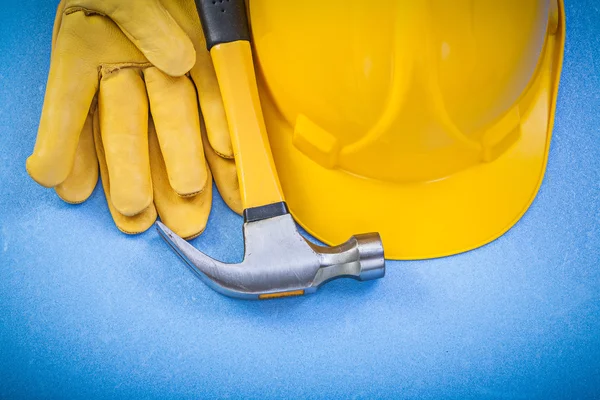 Composición de los guantes de seguridad garra martillo sombrero duro en backgr azul —  Fotos de Stock