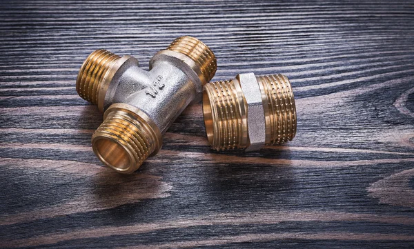 Brass equal tee hose nipple on wooden background plumbing concep — Stock Photo, Image