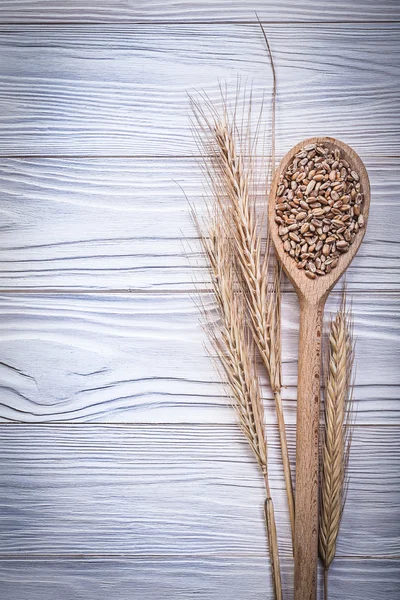 Wheat-rye ears wooden spoon corn on wood board — Stock Photo, Image