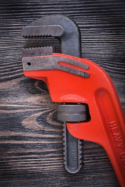 Adjustable monkey wrench on wooden board top view plumbing conce — Stock Photo, Image