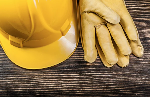 Safety gloves building helmet on wooden board construction conce — Stock Photo, Image