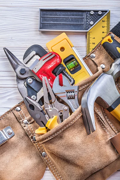 Baugeräte in Werkzeugband auf Holzbrettkonstruktion — Stockfoto