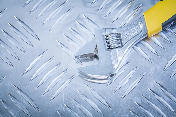 Adjustable spanner on corrugated metal plate construction concep — Stock Photo, Image