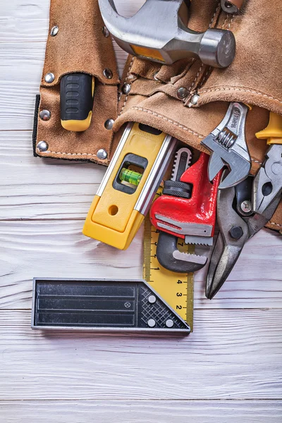 Cinturón de herramientas de cuero con implementos de construcción en const tablero de madera — Foto de Stock