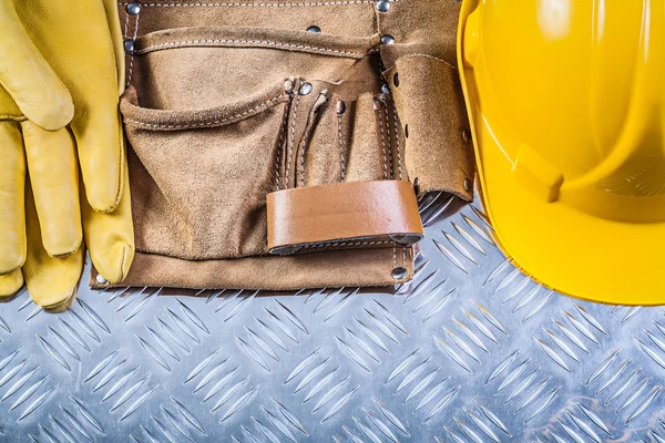 Leather building belt protective gloves hard hat on grooved meta — Stock Photo, Image