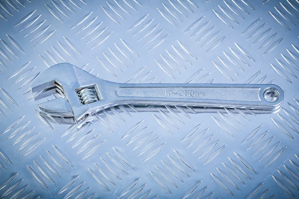 Adjustable wrench on fluted metal sheet construction concept — Stock Photo, Image