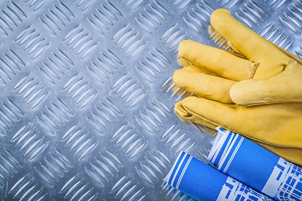 Blue rolled engineering drawings leather protective gloves on co — Stock Photo, Image