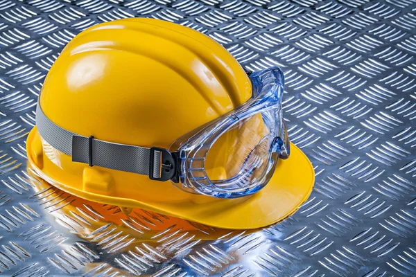 Safety goggles hard hat on fluted metal plate construction conce — Stock Photo, Image