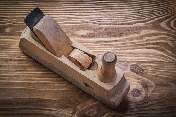 Shaving plane on vintage wooden board — Stock Photo, Image